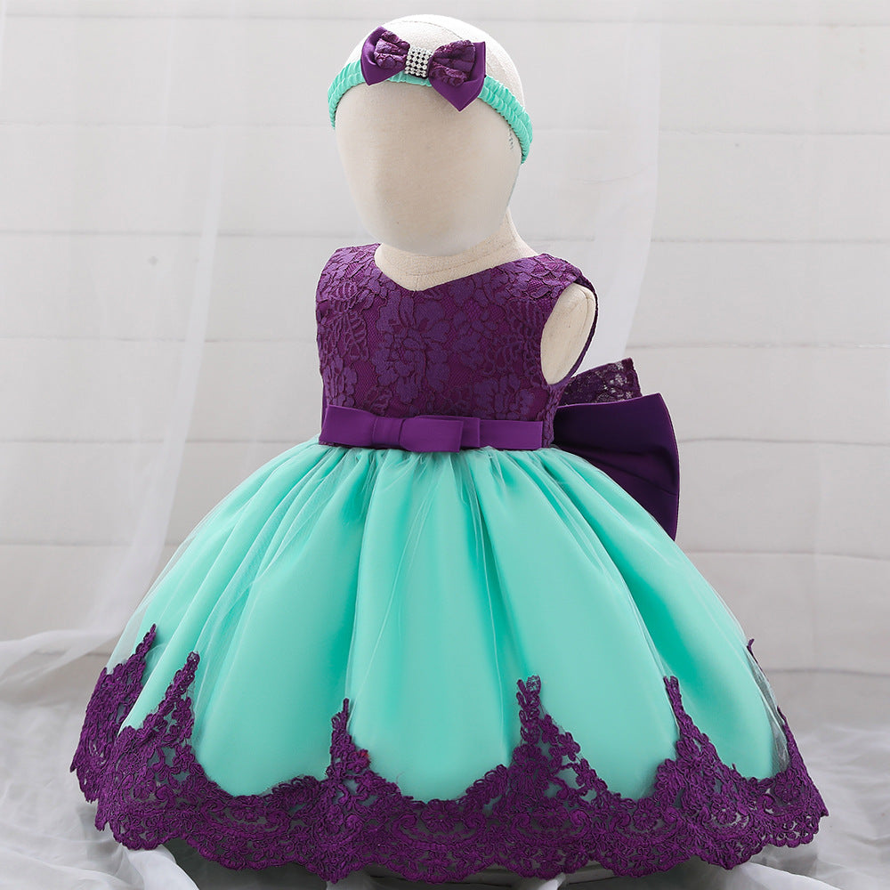 Baby girl wearing a floral mesh overlay formal dress with matching headband, perfect for special occasions.
