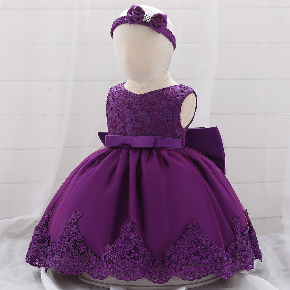 Baby girl wearing a floral mesh overlay formal dress with matching headband, perfect for special occasions.