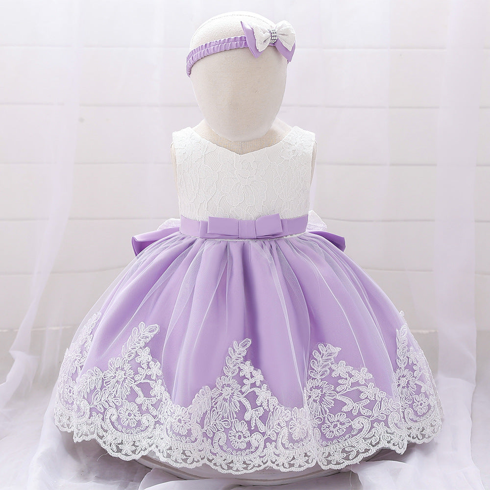 Baby girl wearing a floral mesh overlay formal dress with matching headband, perfect for special occasions.