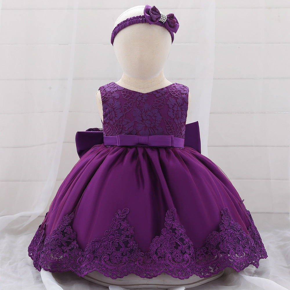 Baby girl wearing a floral mesh overlay formal dress with matching headband, perfect for special occasions.