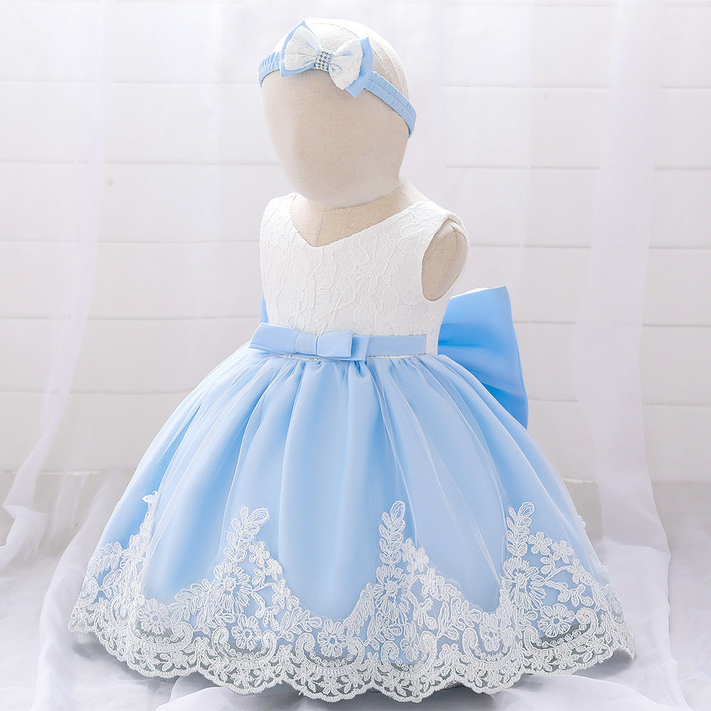 Baby girl wearing a floral mesh overlay formal dress with matching headband, perfect for special occasions.