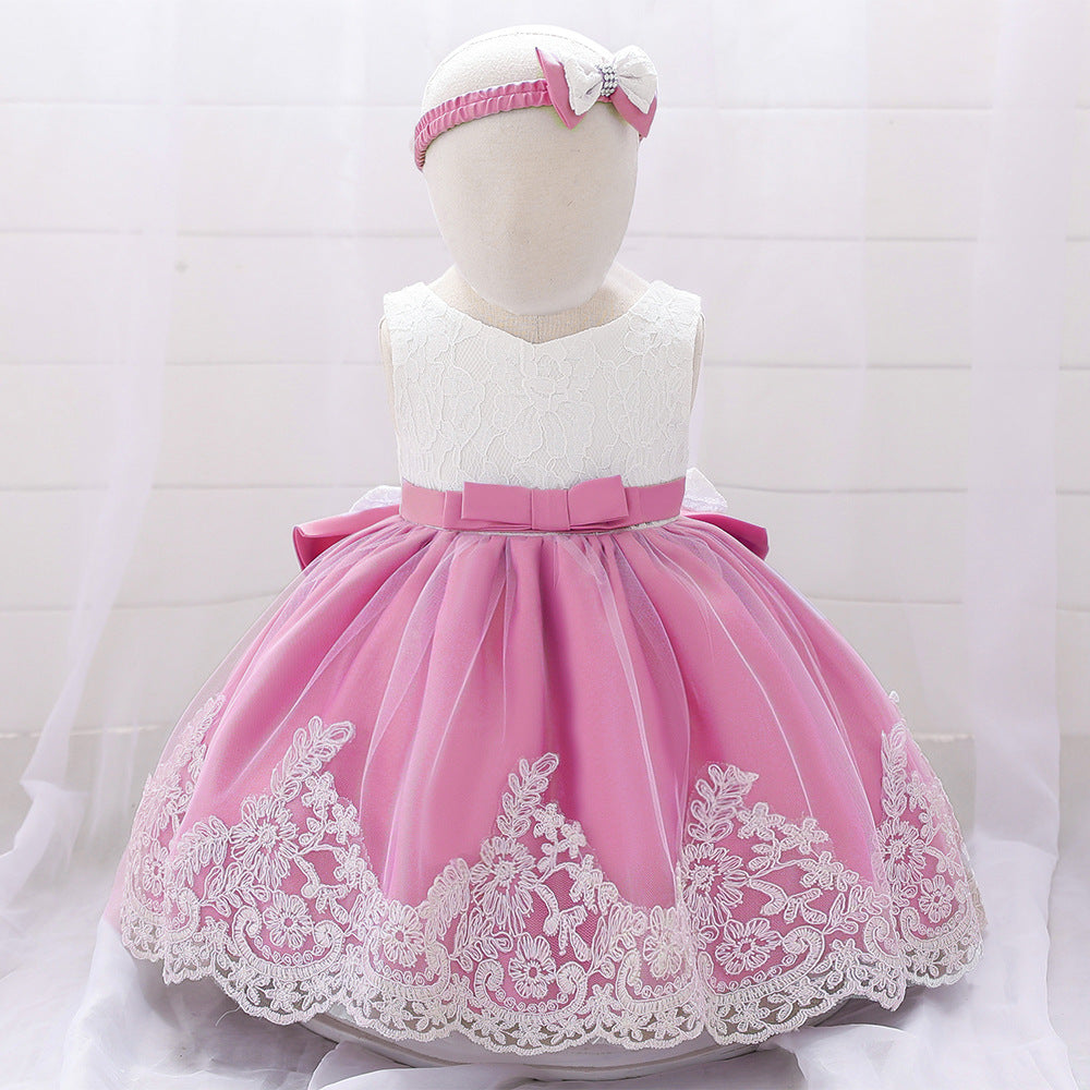 Baby girl wearing a floral mesh overlay formal dress with matching headband, perfect for special occasions.