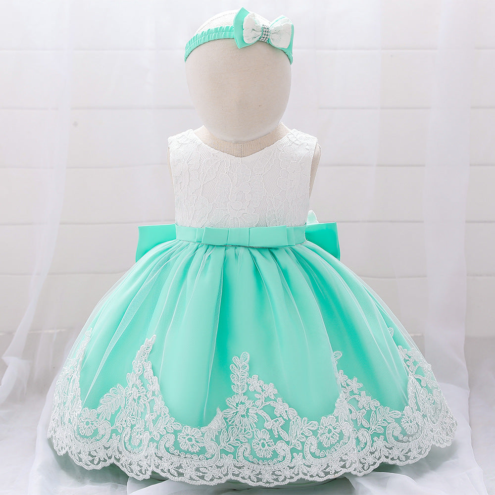 Baby girl wearing a floral mesh overlay formal dress with matching headband, perfect for special occasions.