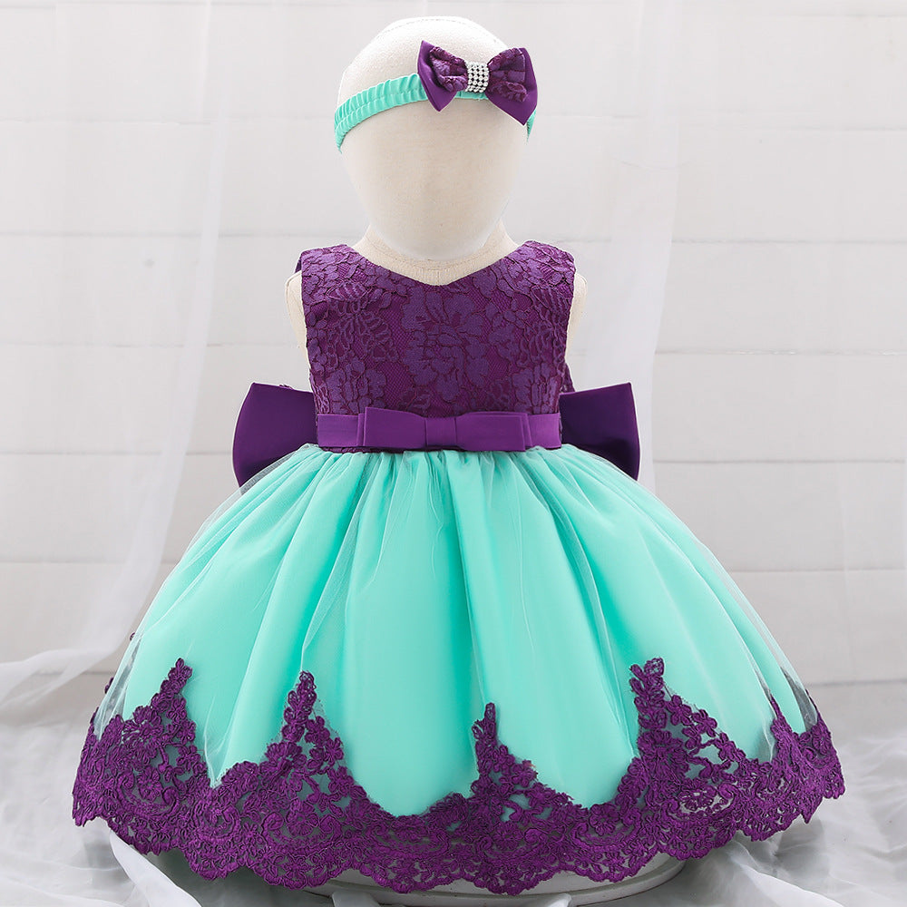Baby girl wearing a floral mesh overlay formal dress with matching headband, perfect for special occasions.