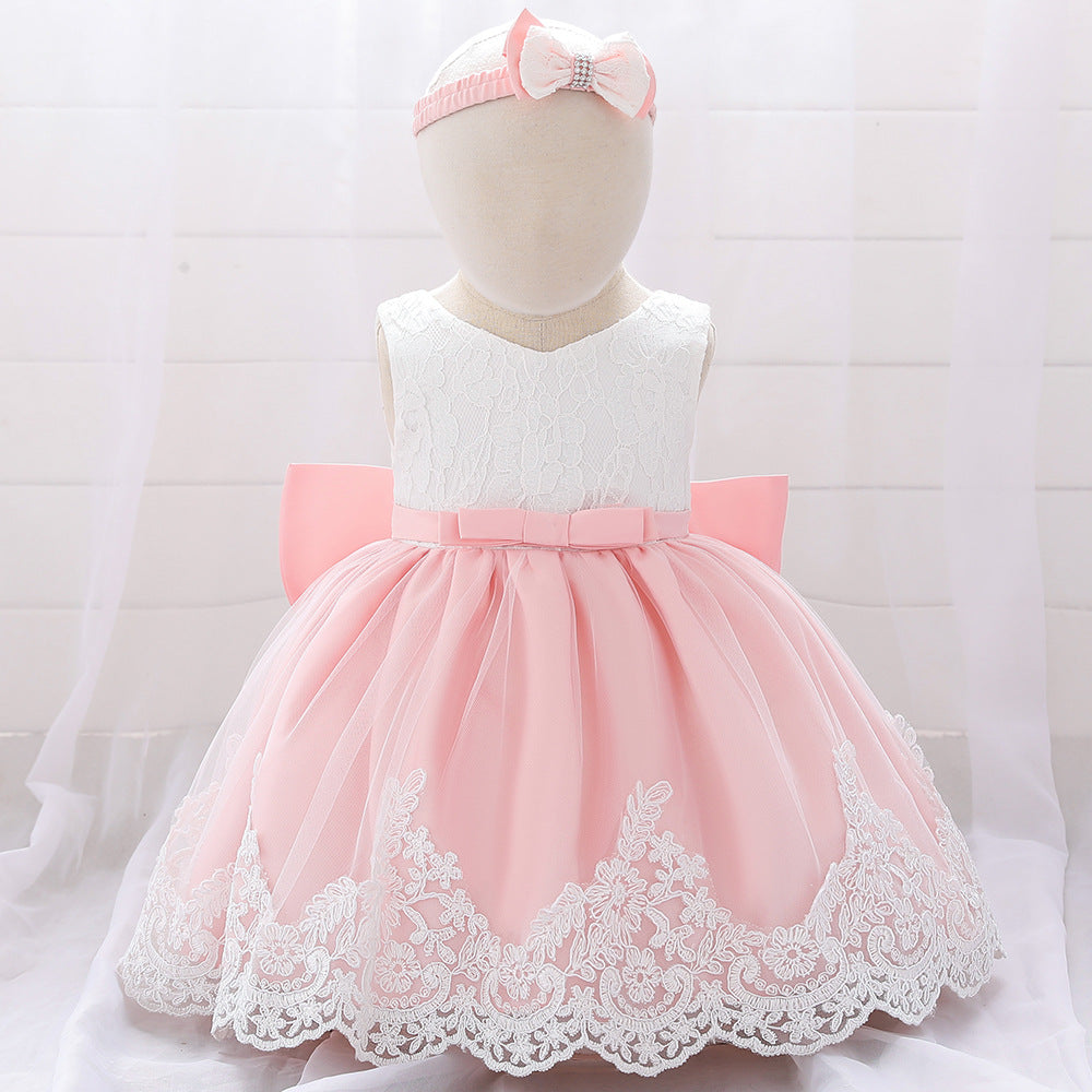 Baby girl wearing a floral mesh overlay formal dress with matching headband, perfect for special occasions.