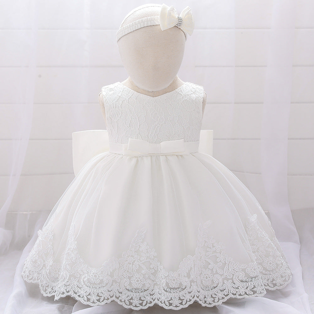 Baby girl wearing a floral mesh overlay formal dress with matching headband, perfect for special occasions.