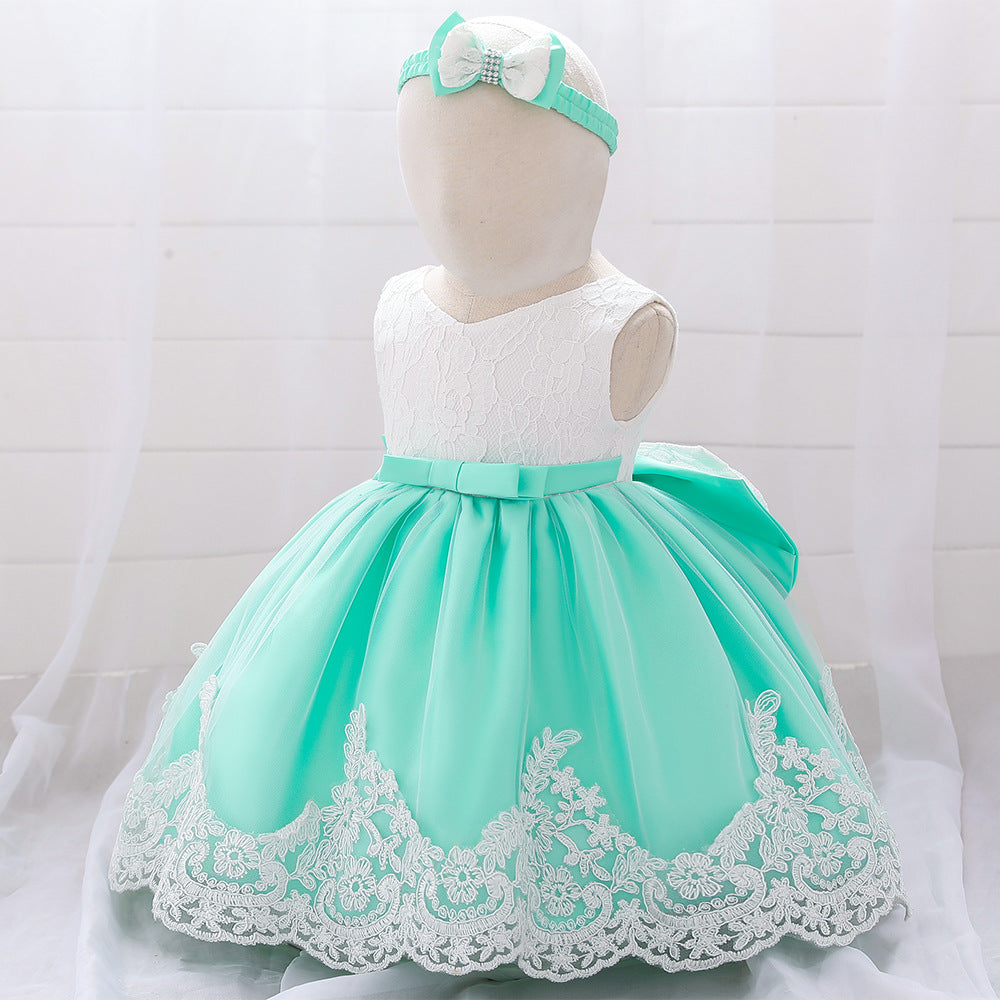 Baby girl wearing a floral mesh overlay formal dress with matching headband, perfect for special occasions.