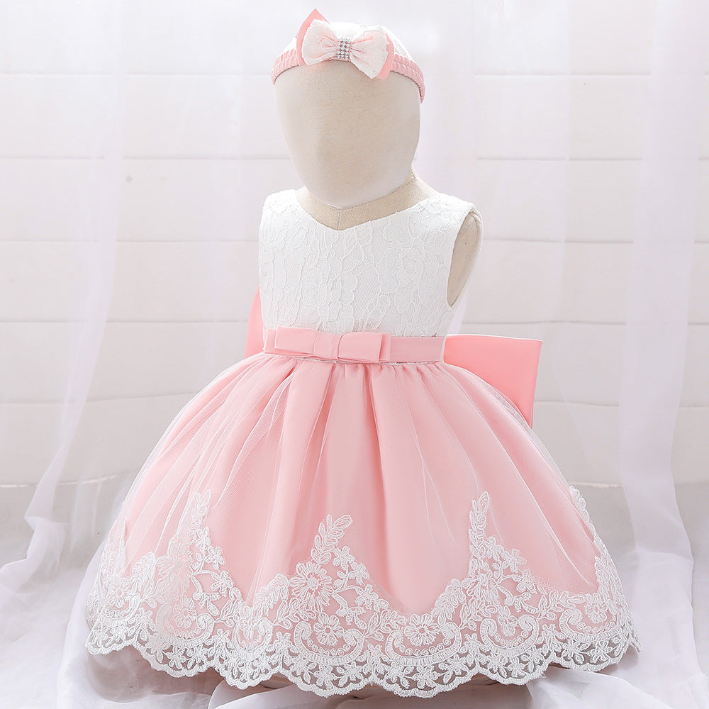 Baby girl wearing a floral mesh overlay formal dress with matching headband, perfect for special occasions.