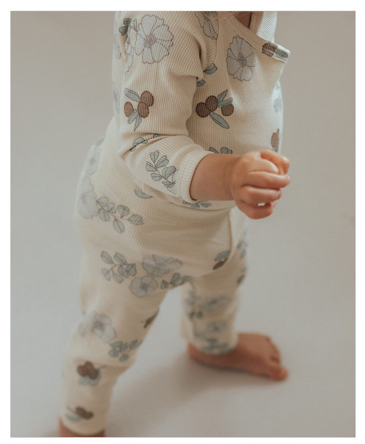 Baby girl floral pattern cotton onesie set featuring a soft onesie and matching pants in green and apricot colors.