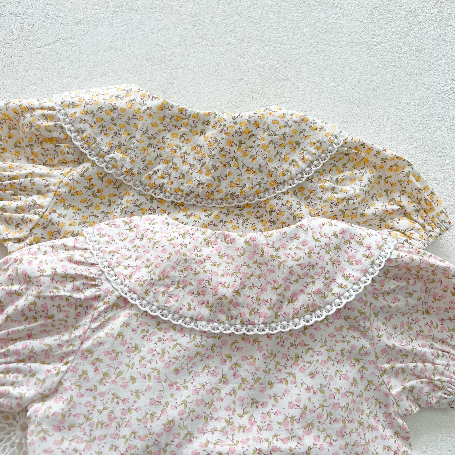 Baby girl floral pattern onesies dress with mesh patches in pink and yellow, perfect for summer wear.