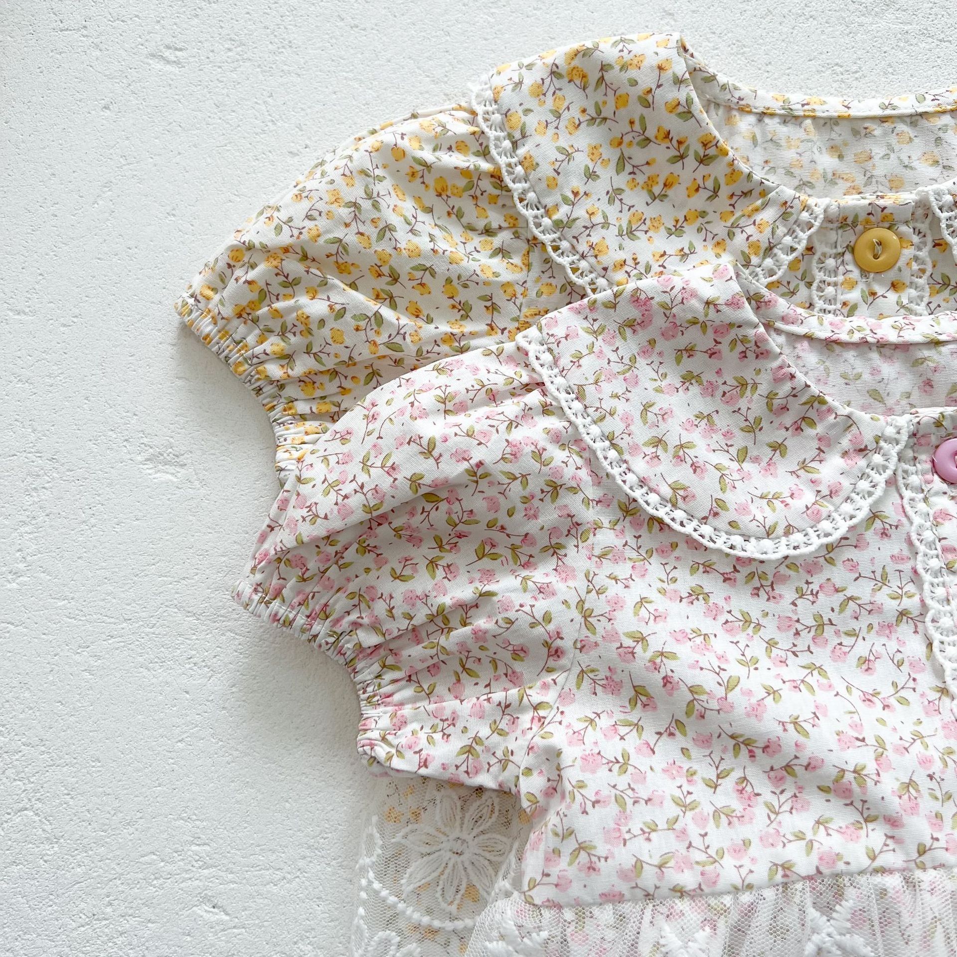 Baby girl floral pattern onesies dress with mesh patches in pink and yellow, perfect for summer wear.