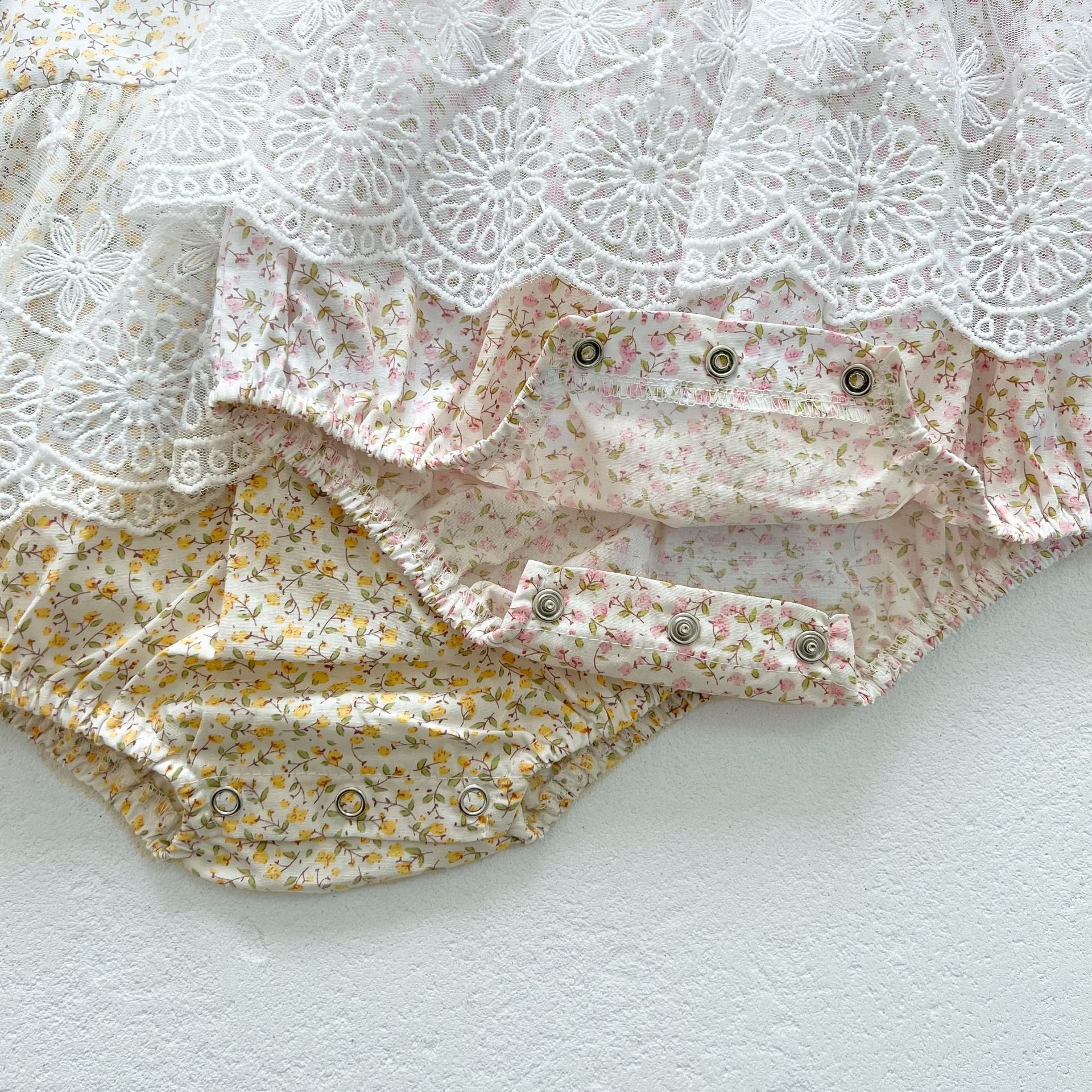 Baby girl floral pattern onesies dress with mesh patches in pink and yellow, perfect for summer wear.
