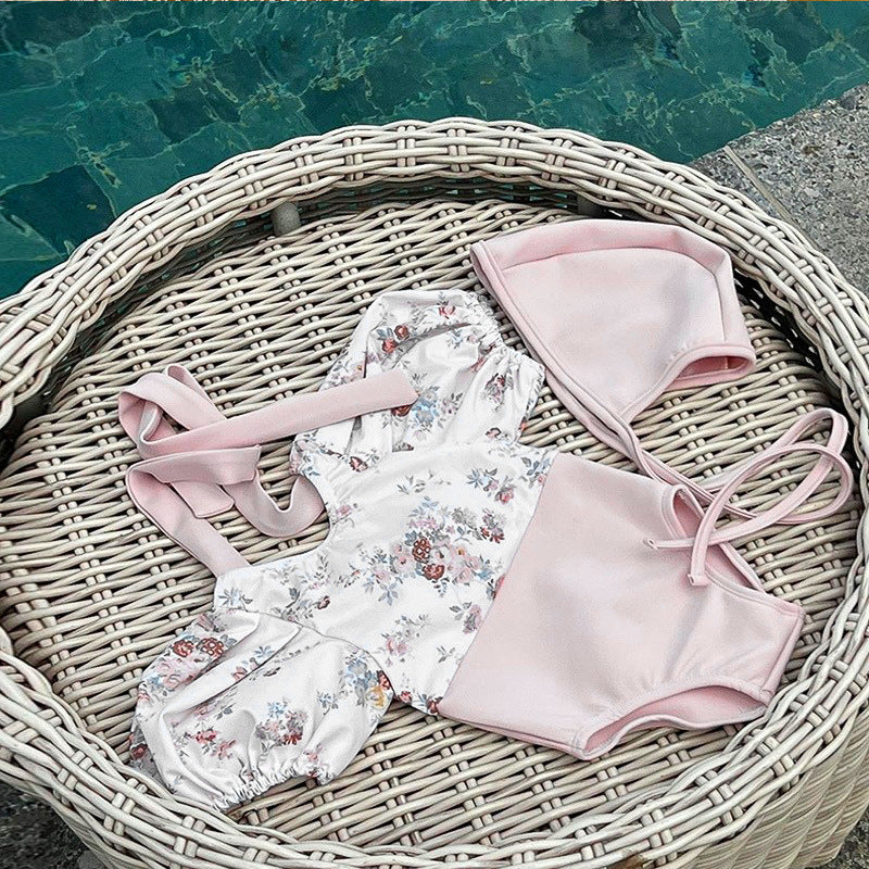 Baby girl swimwear featuring floral pattern and puff sleeves, accompanied by a matching sun hat, perfect for summer outings.