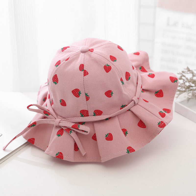 Baby girl wearing a floral print adjustable sunshade bucket hat in various colors, perfect for sun protection.