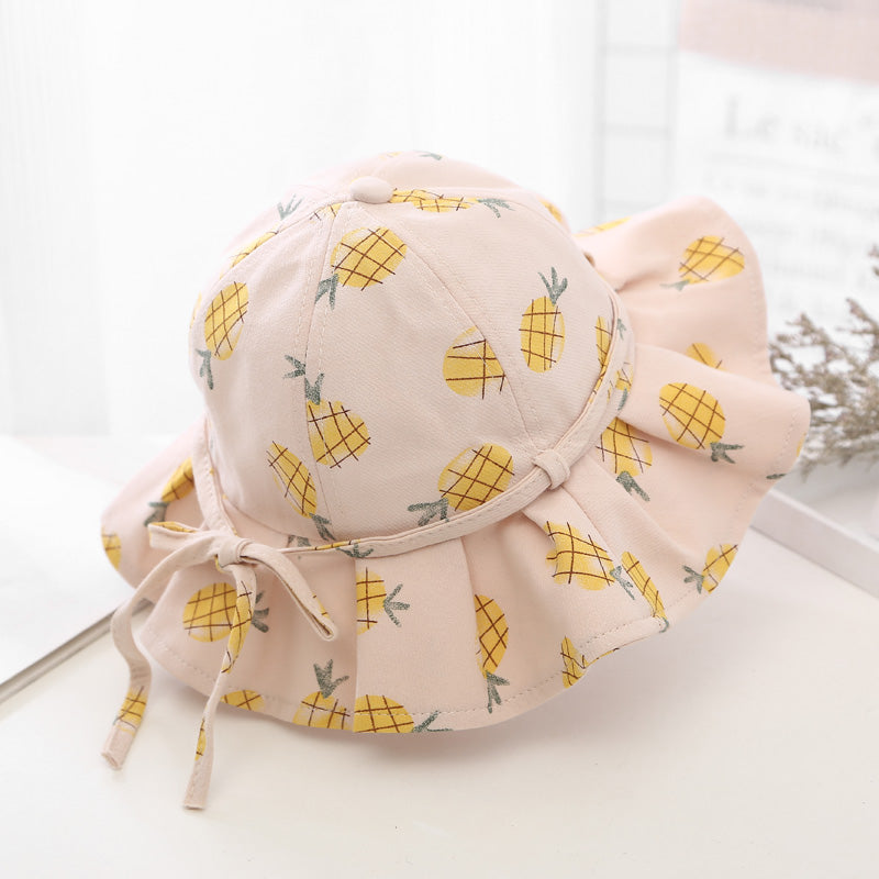Baby girl wearing a floral print adjustable sunshade bucket hat in various colors, perfect for sun protection.