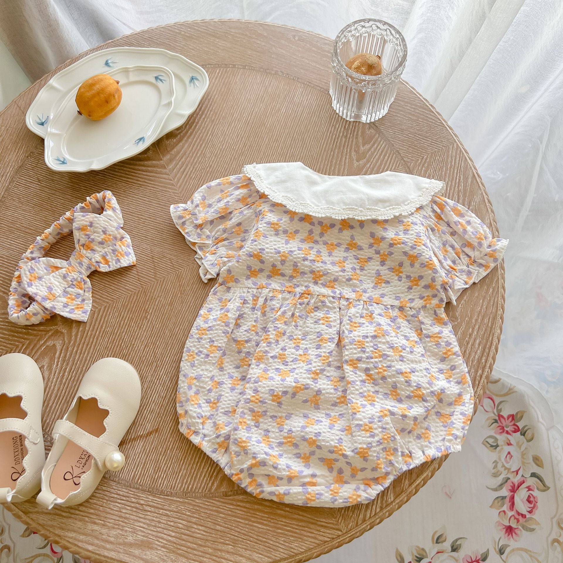 Baby girl floral print onesie with embroidered collar, perfect for summer wear.