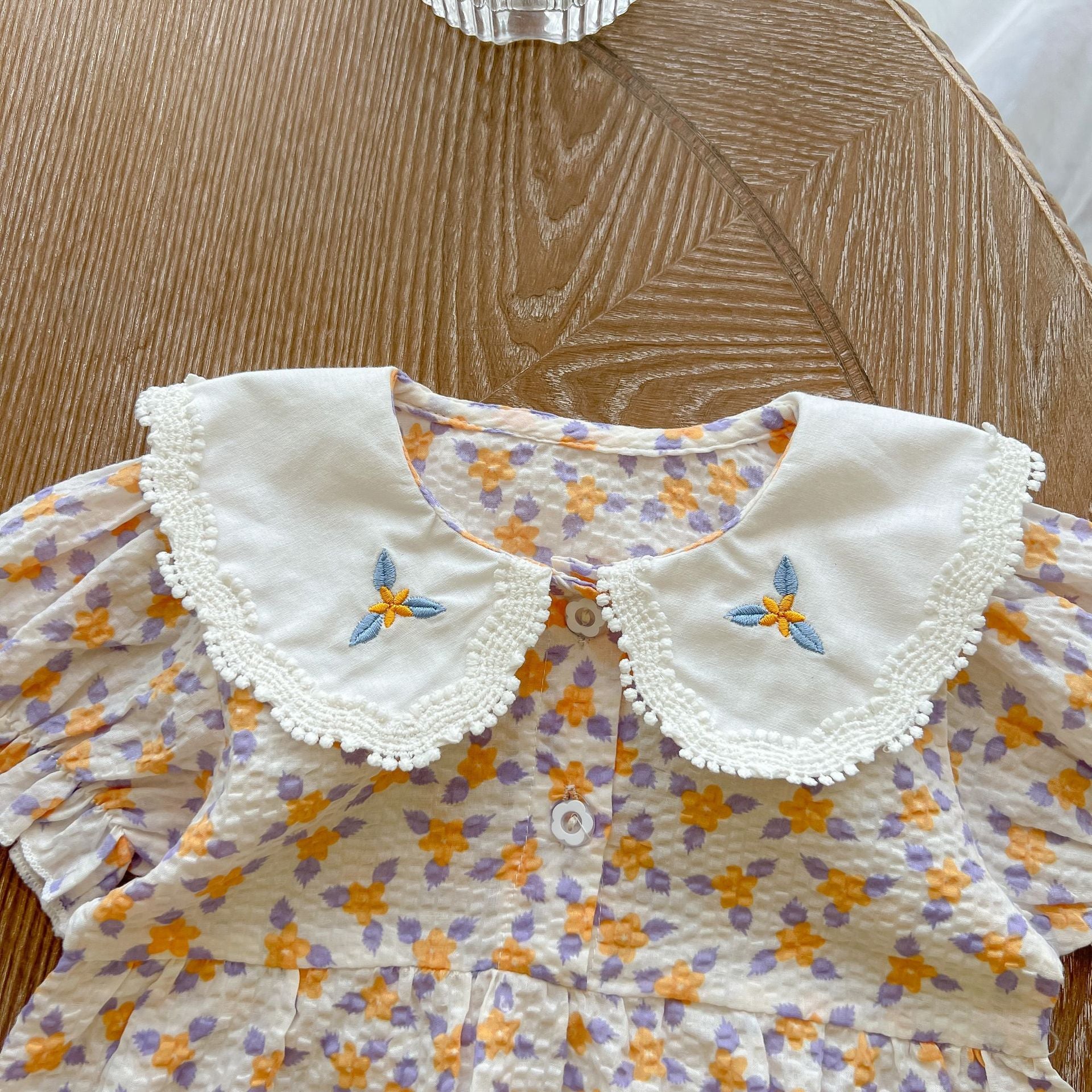 Baby girl floral print onesie with embroidered collar, perfect for summer wear.