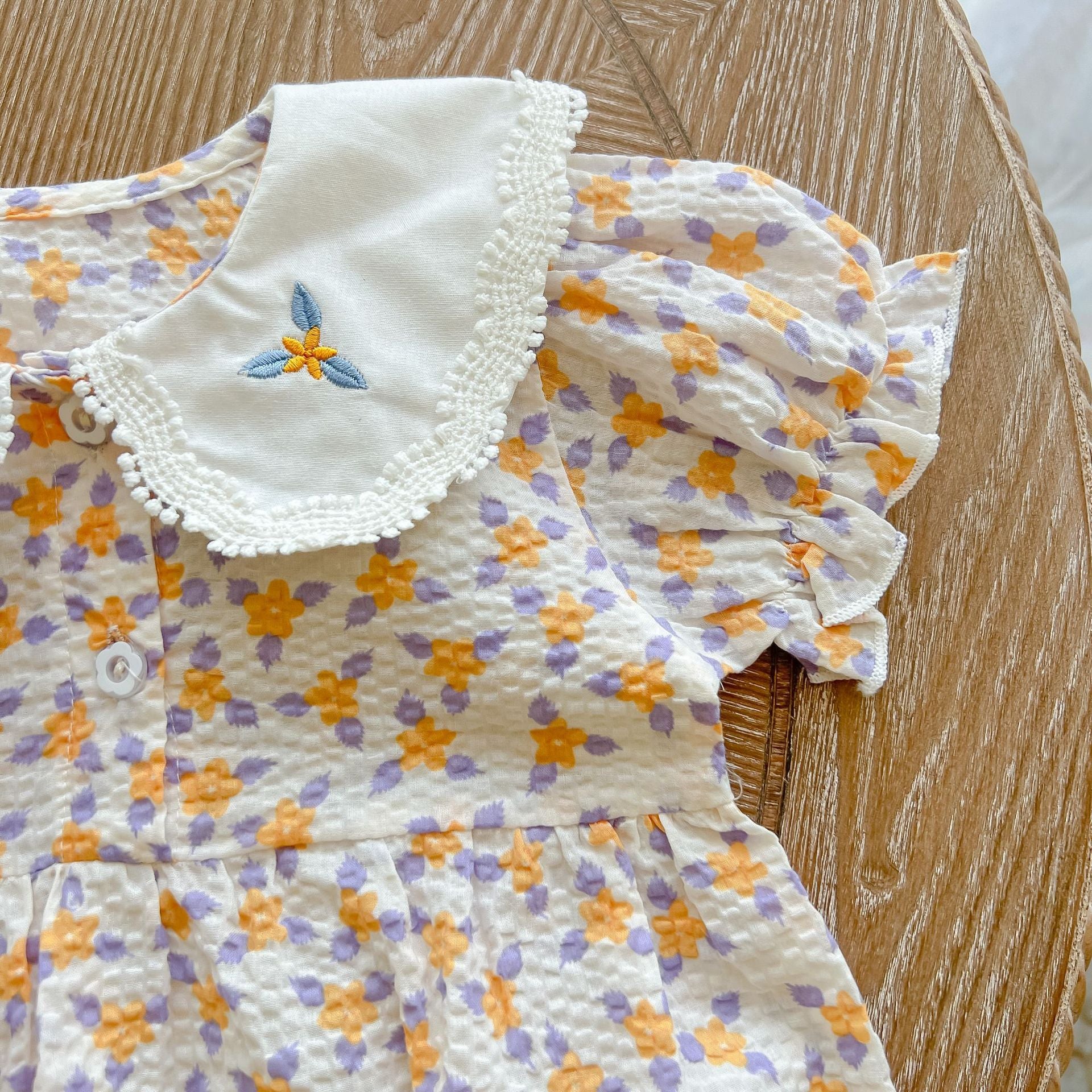 Baby girl floral print onesie with embroidered collar, perfect for summer wear.