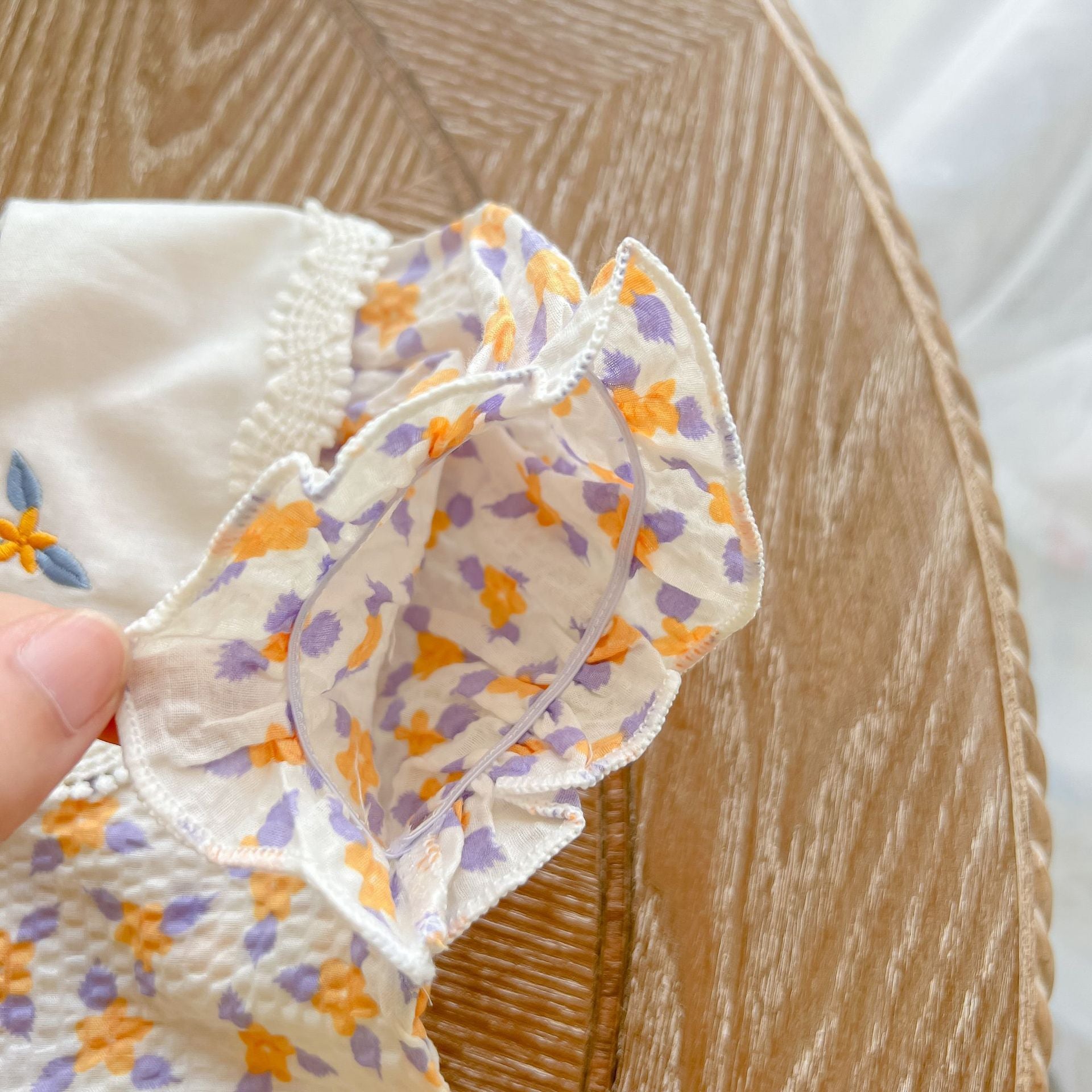 Baby girl floral print onesie with embroidered collar, perfect for summer wear.