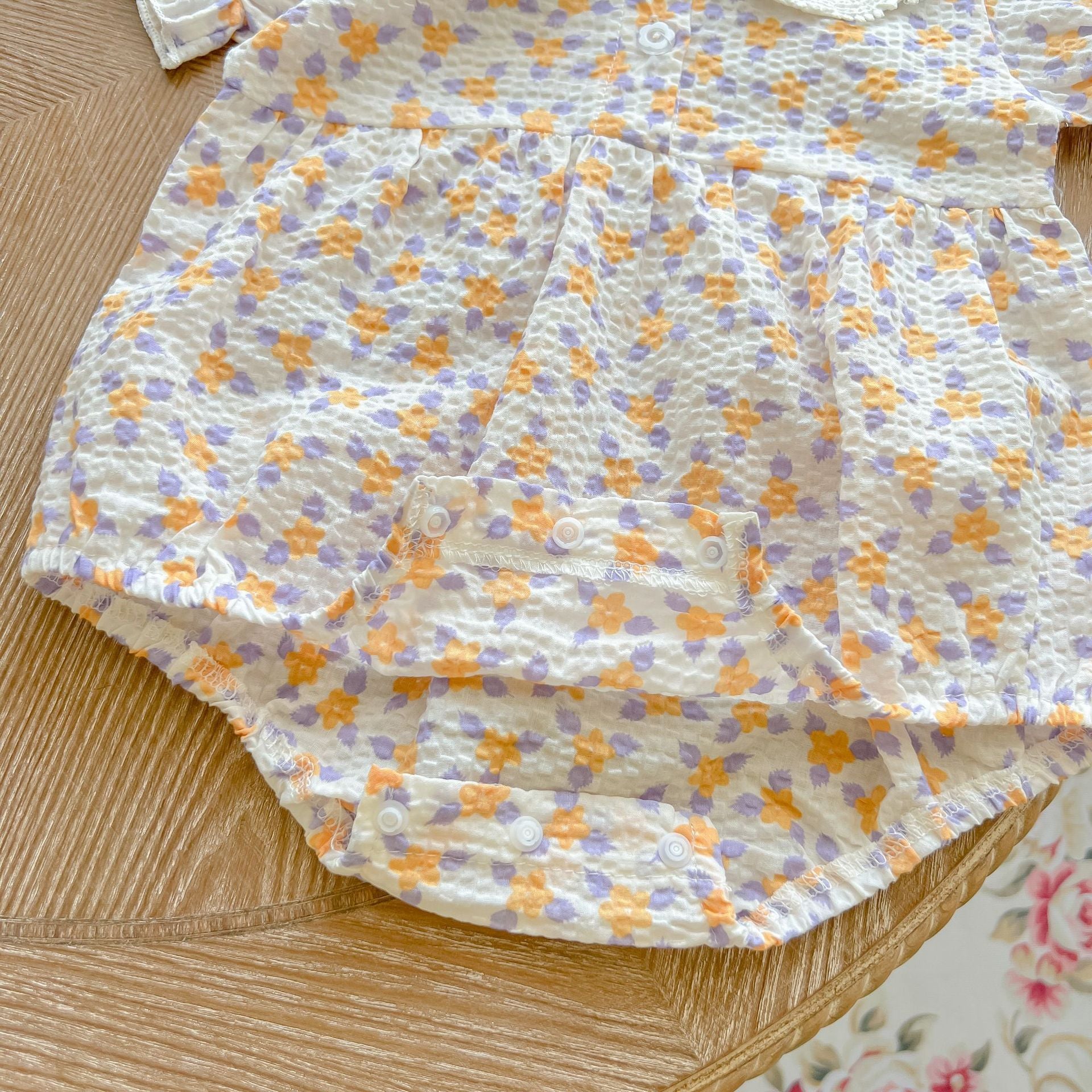 Baby girl floral print onesie with embroidered collar, perfect for summer wear.