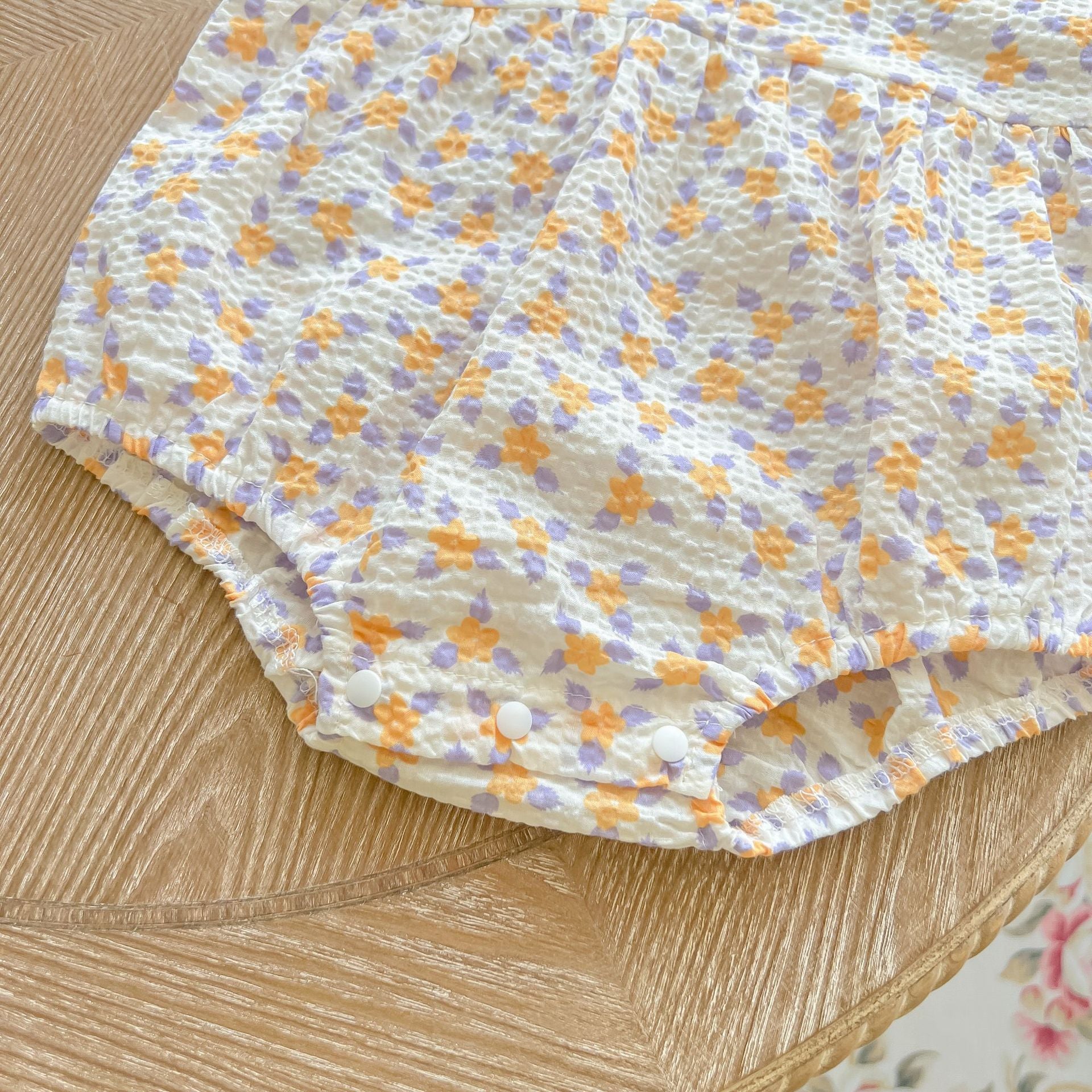 Baby girl floral print onesie with embroidered collar, perfect for summer wear.