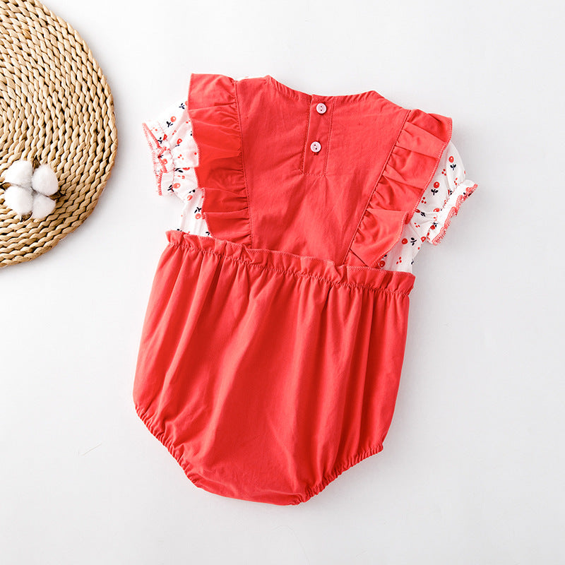 Baby girl onesie featuring floral print, lace patchwork, and ruffle design in vibrant red color.