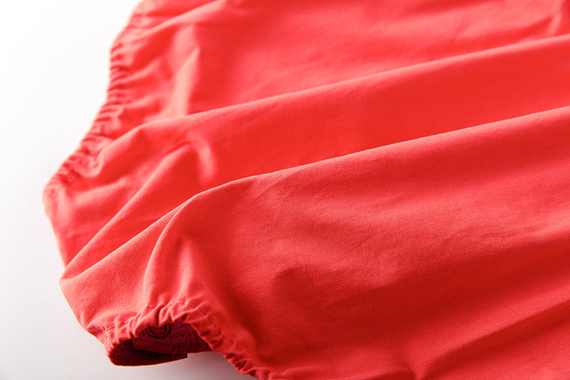 Baby girl onesie featuring floral print, lace patchwork, and ruffle design in vibrant red color.