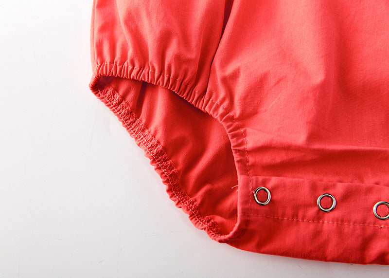 Baby girl onesie featuring floral print, lace patchwork, and ruffle design in vibrant red color.