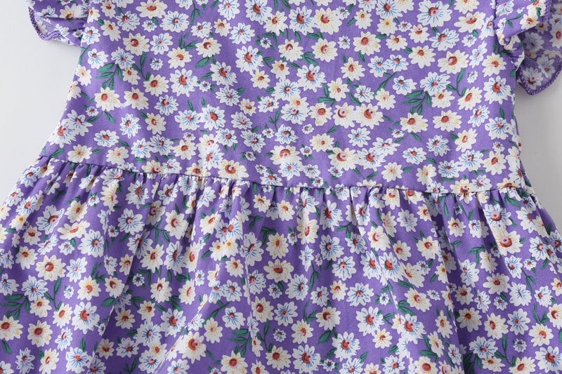 Baby girl wearing a floral print onesie with a matching headband, perfect for summer outings.