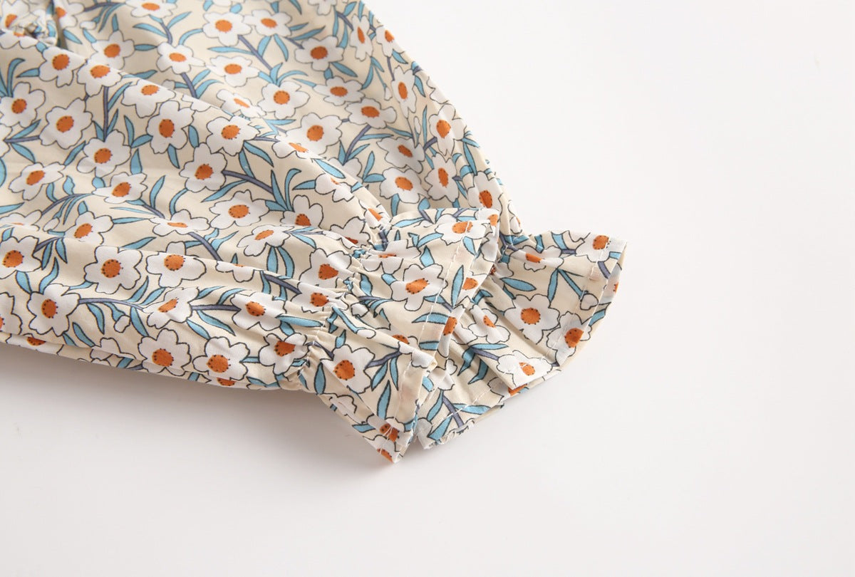 Baby girl floral print onesie with color blocking design, featuring long sleeves and a round collar, made from soft cotton fabric.