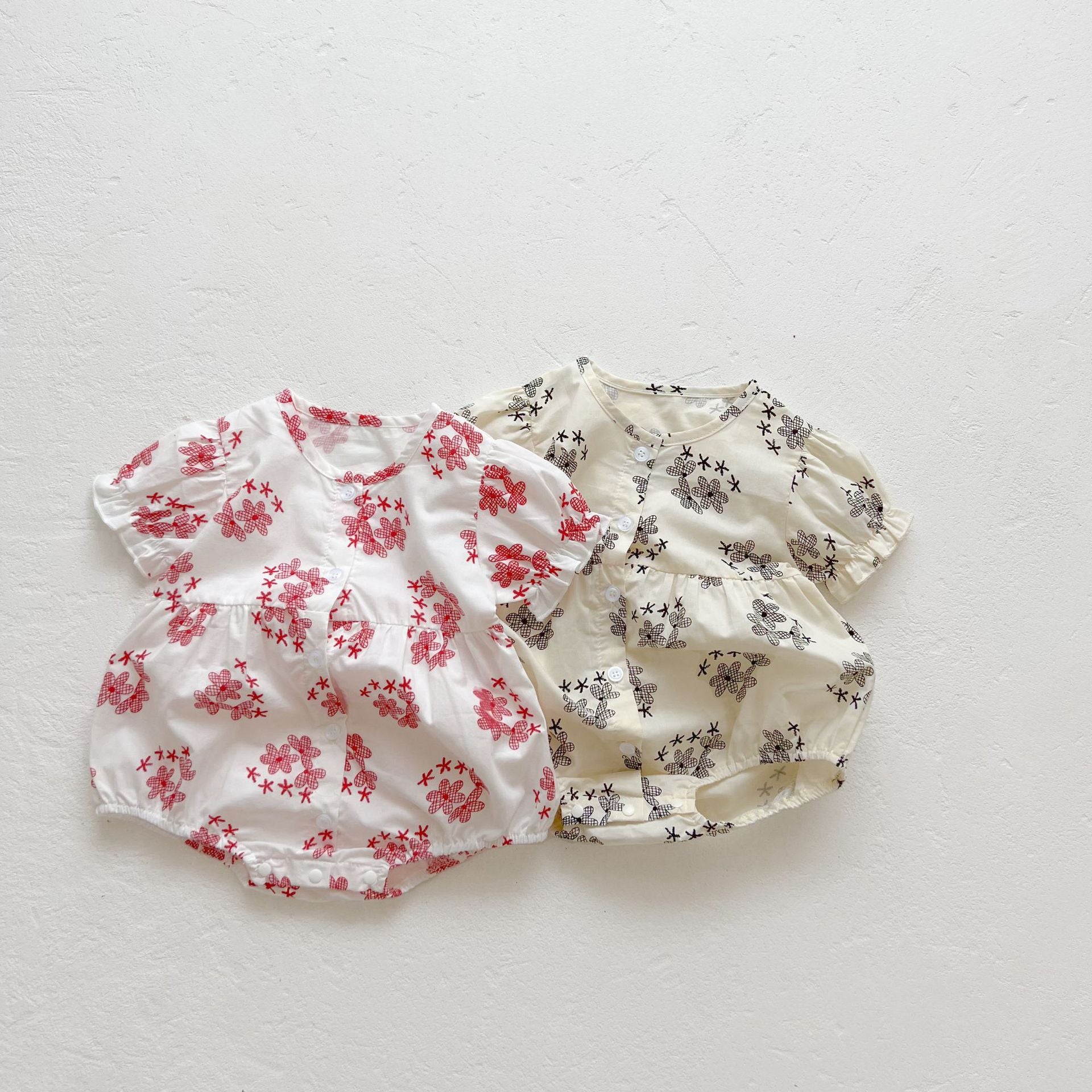 Baby girl floral print onesies with round collar and buttons in black and red colors, perfect for summer wear.