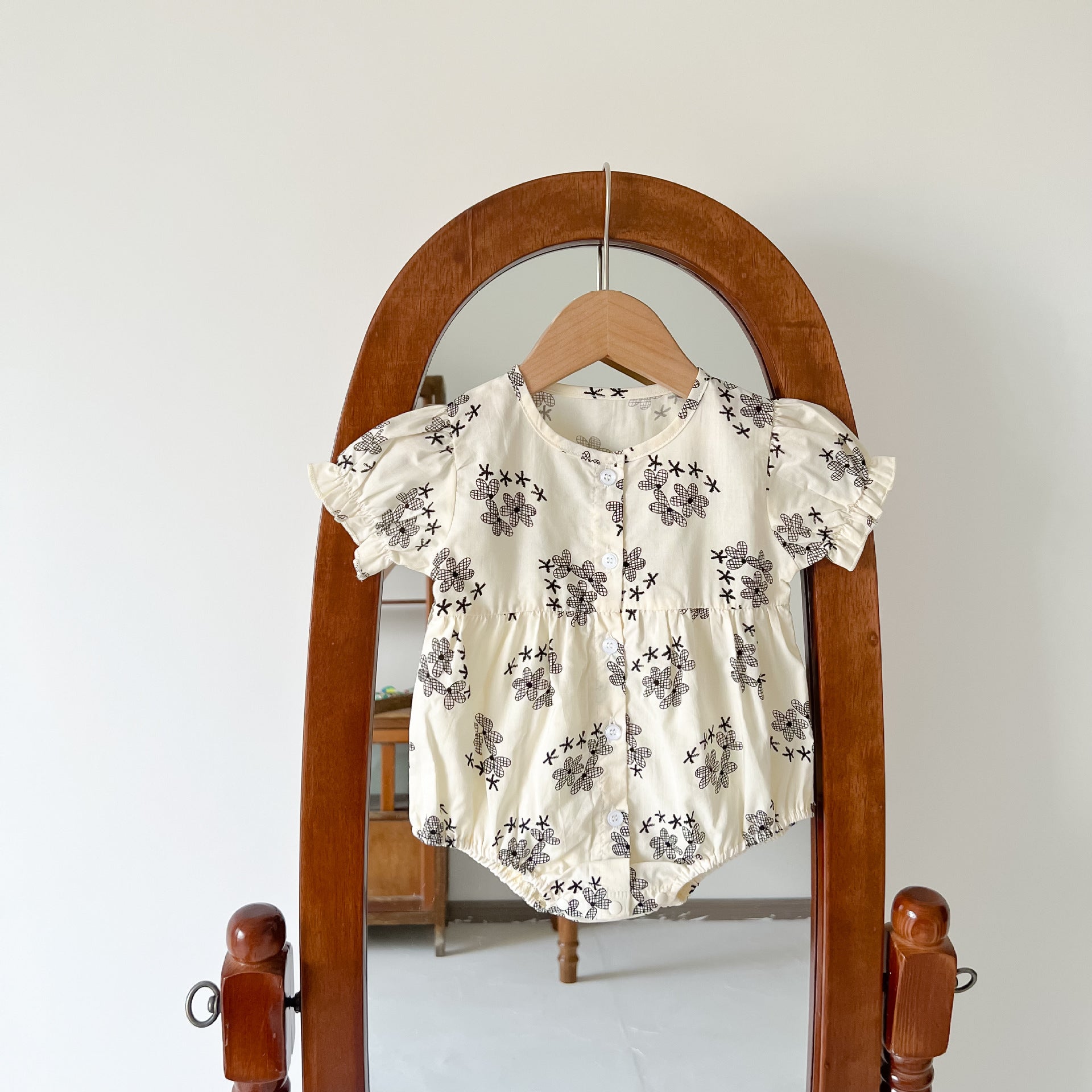 Baby girl floral print onesies with round collar and buttons in black and red colors, perfect for summer wear.