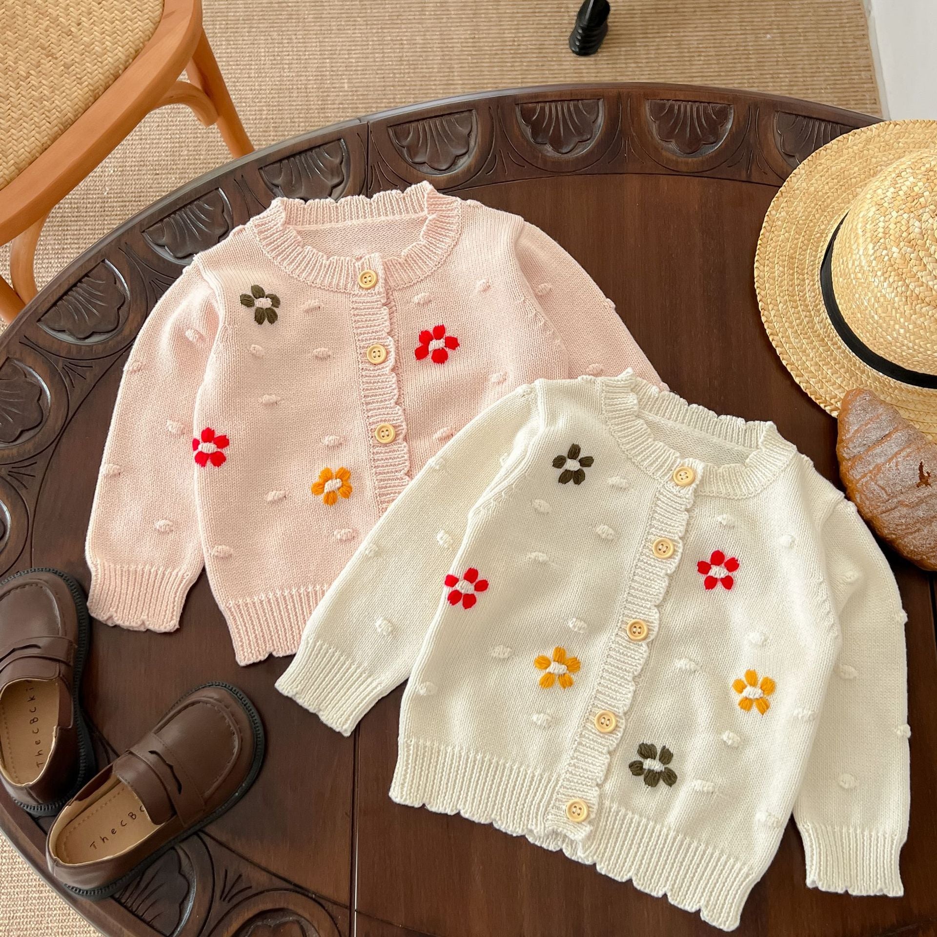 Baby girl cardigan featuring flower embroidery in white and pink colors, designed for comfort and style.