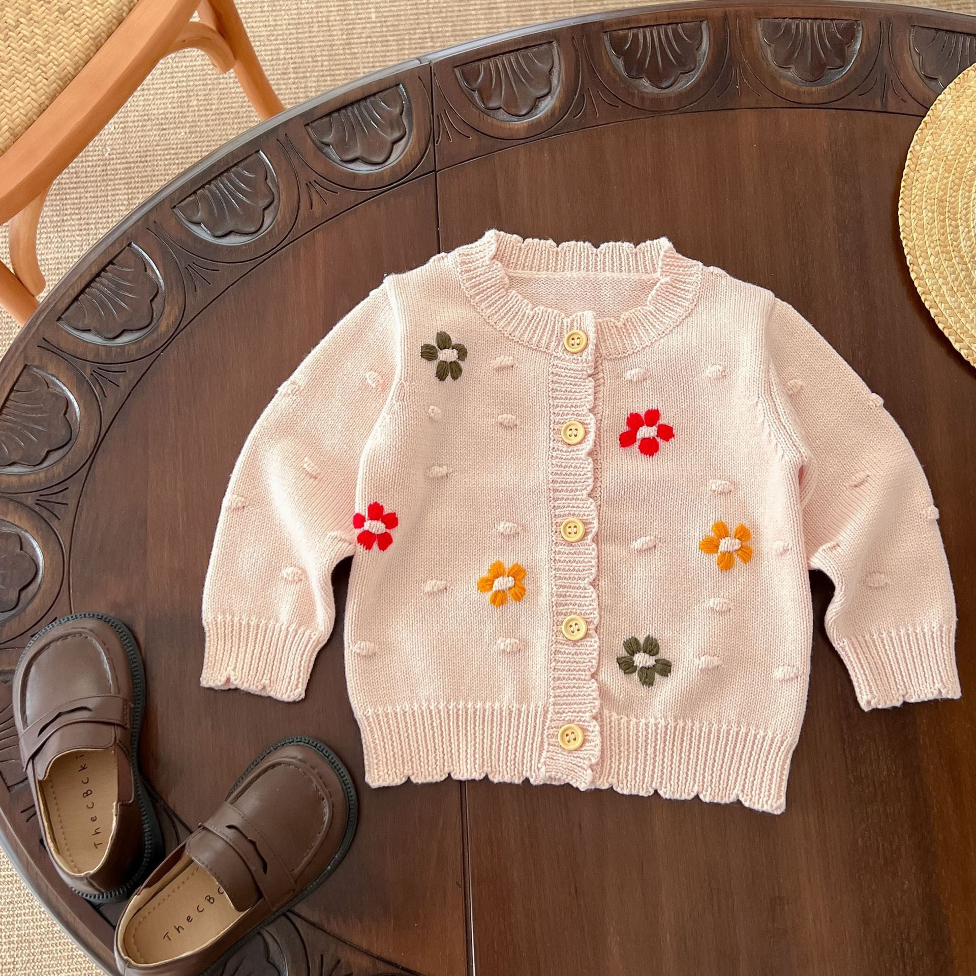 Baby girl cardigan featuring flower embroidery in white and pink colors, designed for comfort and style.