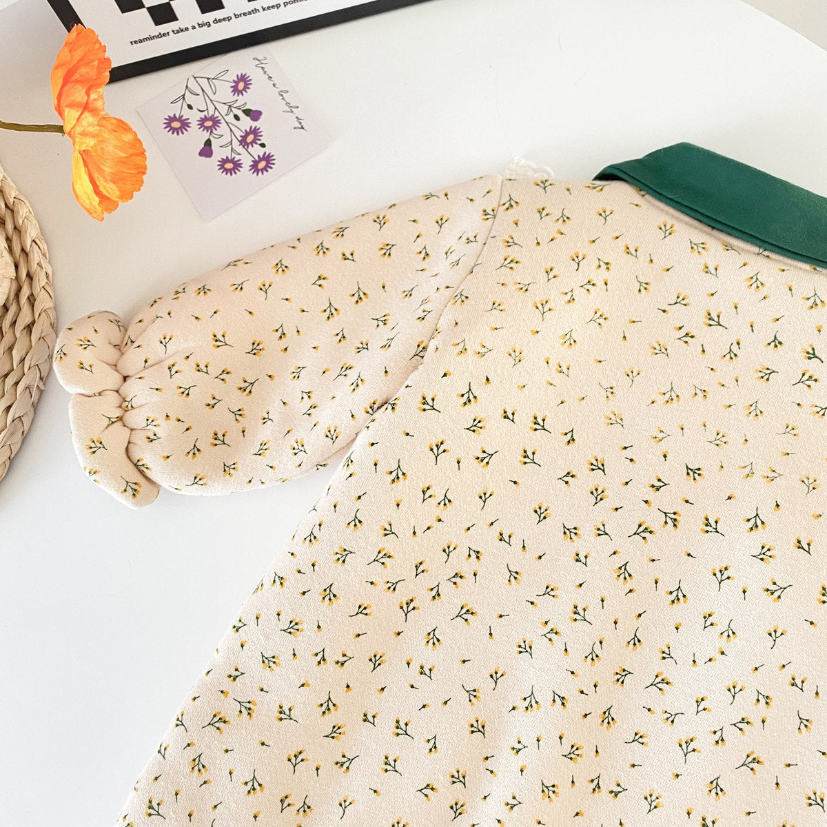 Baby girl romper featuring floral print and fleece patchwork design, perfect for winter wear.