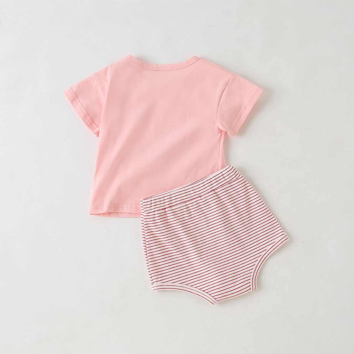 Baby girl wearing a colorful fruit pattern short sleeve top and striped graphic shorts, perfect for summer outings.