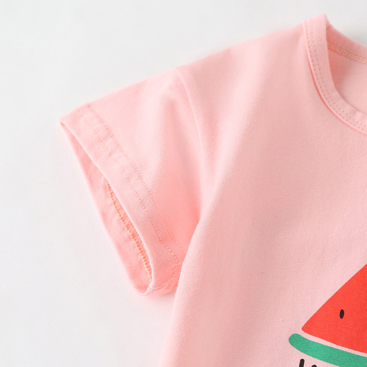 Baby girl wearing a colorful fruit pattern short sleeve top and striped graphic shorts, perfect for summer outings.