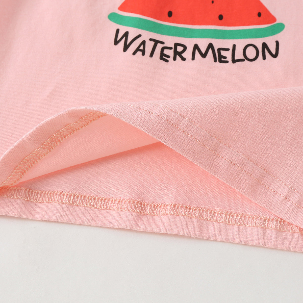 Baby girl wearing a colorful fruit pattern short sleeve top and striped graphic shorts, perfect for summer outings.