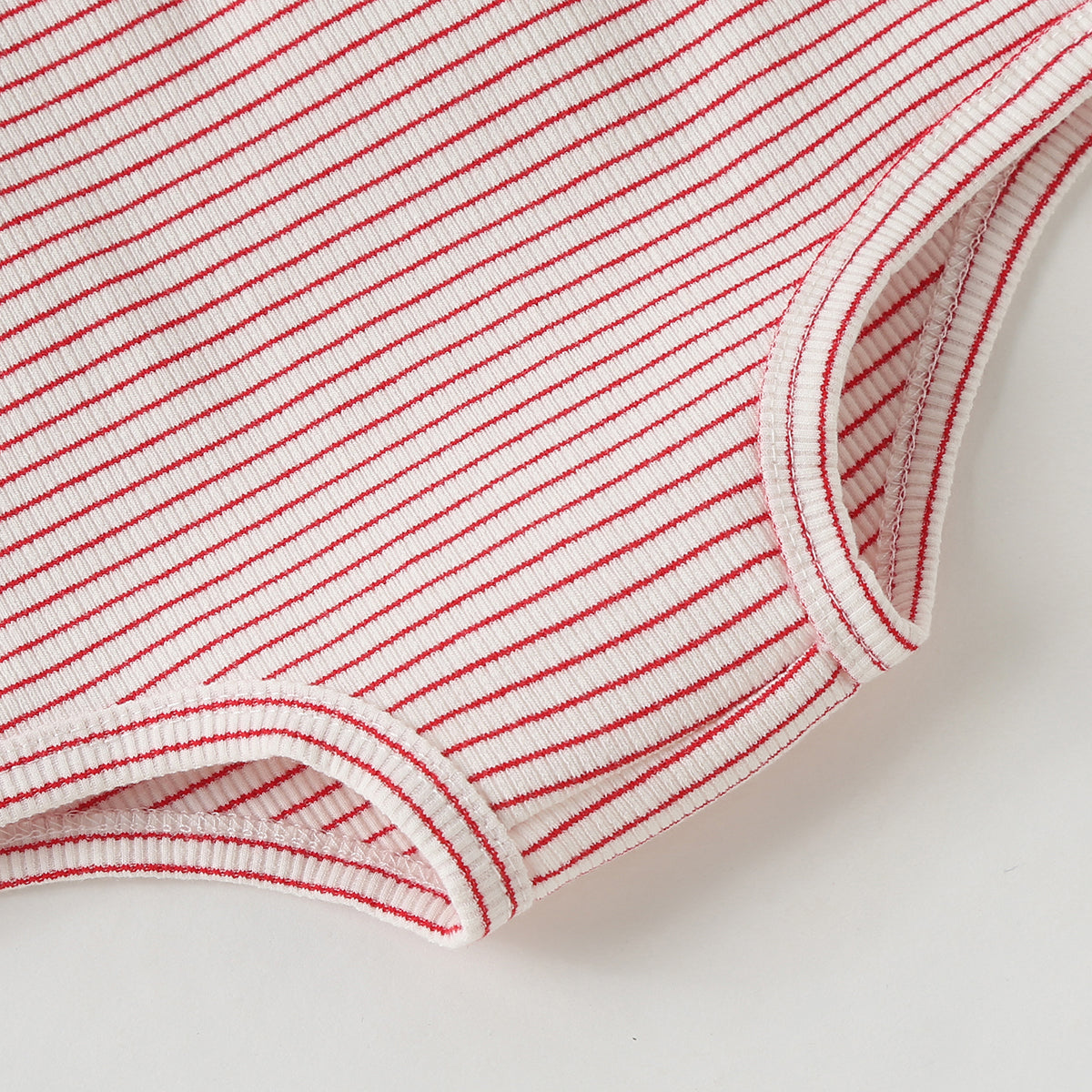 Baby girl wearing a colorful fruit pattern short sleeve top and striped graphic shorts, perfect for summer outings.