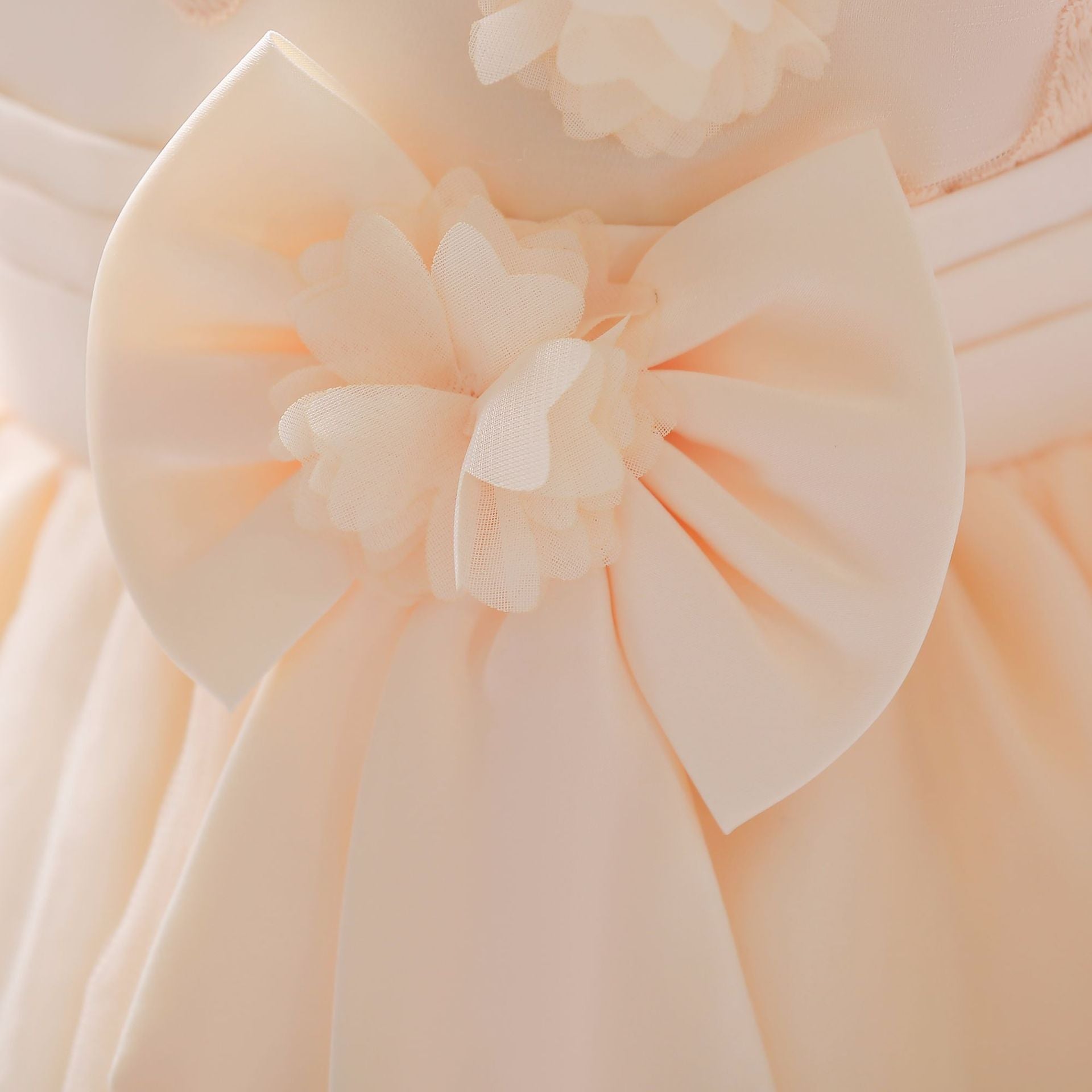 Baby girl wearing a Full Moon Christening Trailing Tutu Formal Dress in white, showcasing delicate tulle fabric and a graceful trailing skirt.