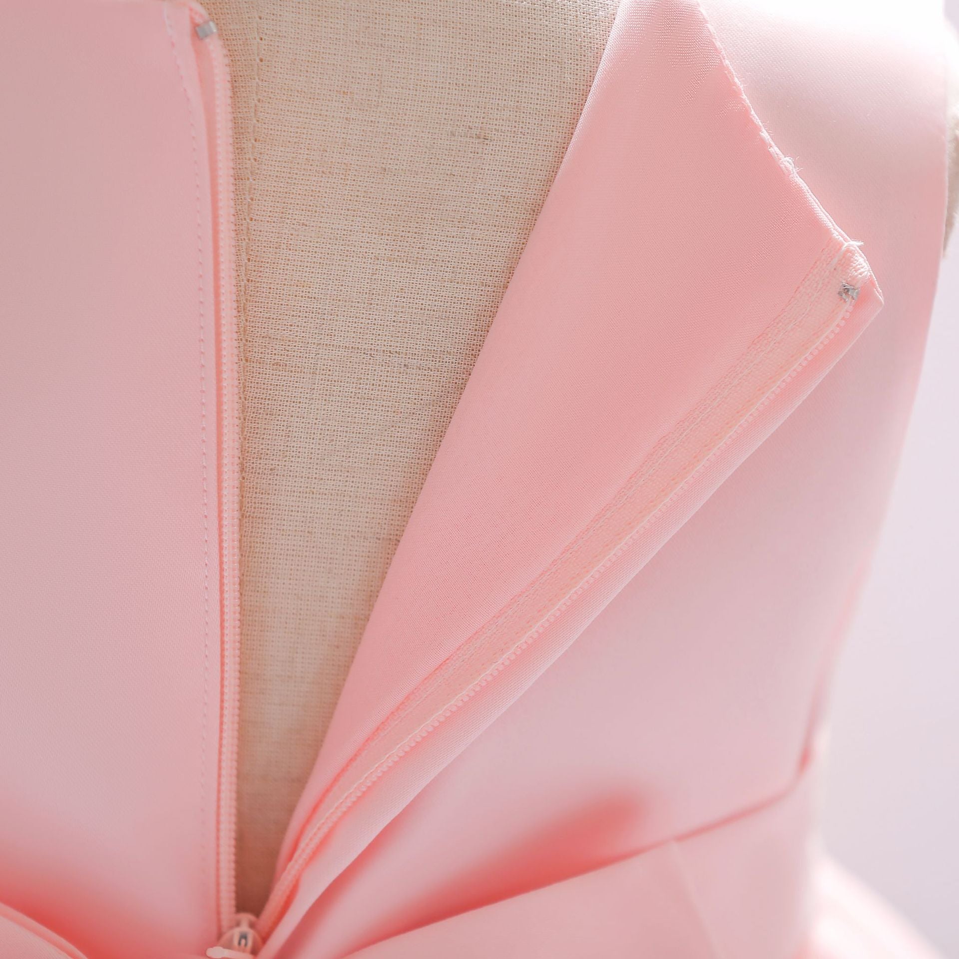 Baby girl wearing a Full Moon Christening Trailing Tutu Formal Dress in white, showcasing delicate tulle fabric and a graceful trailing skirt.