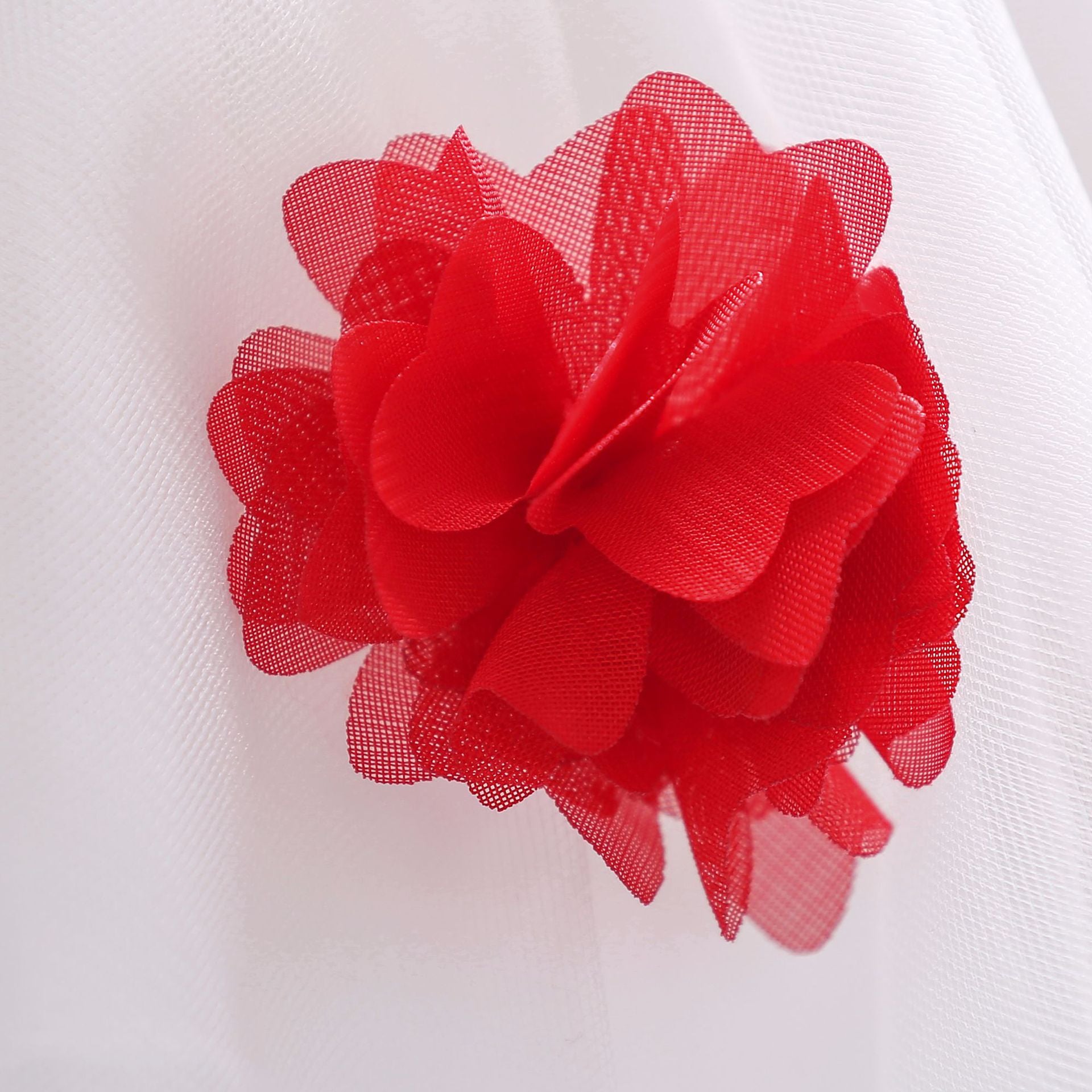 Baby girl wearing a Full Moon Christening Trailing Tutu Formal Dress in white, showcasing delicate tulle fabric and a graceful trailing skirt.