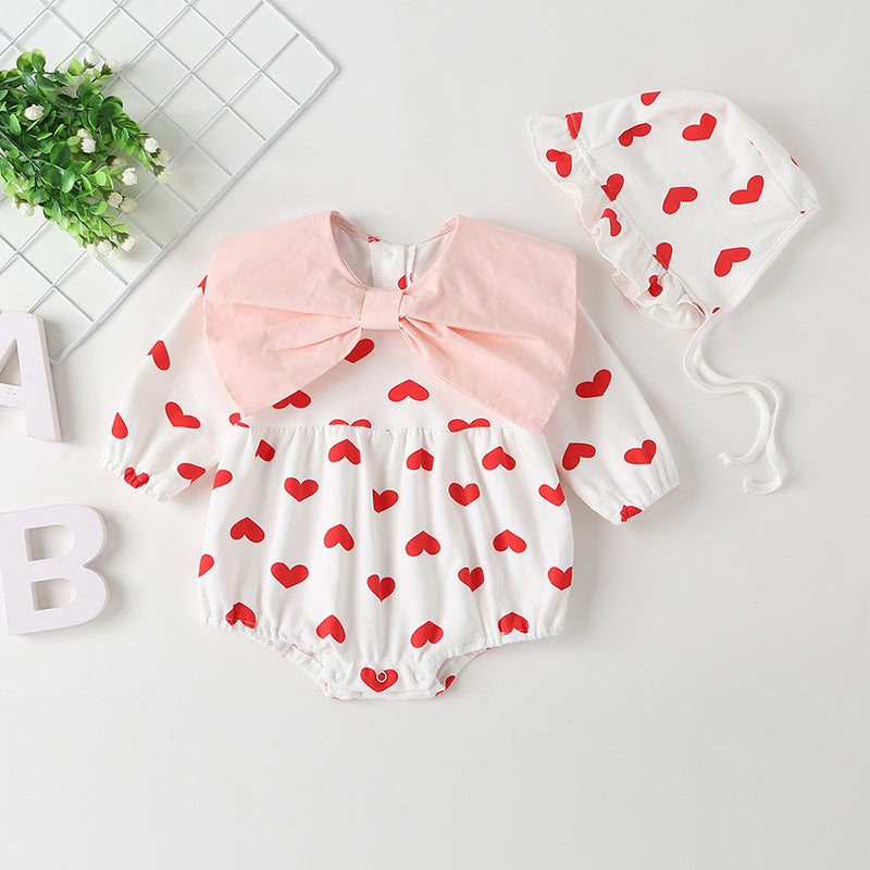 Baby girl onesie featuring a heart pattern and big bow tie, designed for comfort and style.