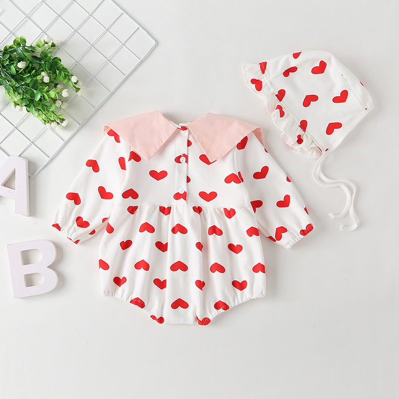 Baby girl onesie featuring a heart pattern and big bow tie, designed for comfort and style.