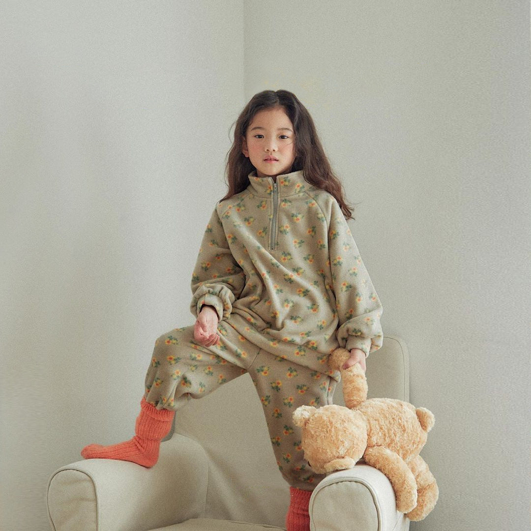Baby girl wearing a high neck jacquard thick warm two pieces set in grey with floral pattern.