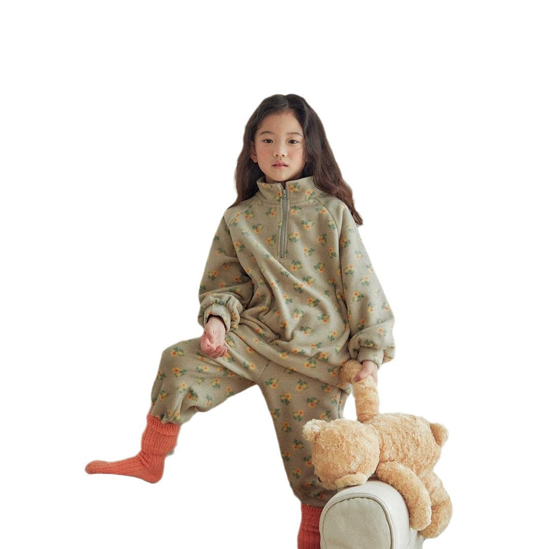 Baby girl wearing a high neck jacquard thick warm two pieces set in grey with floral pattern.