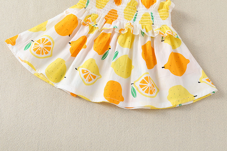 Baby girl wearing a lemon fruit print sleeveless dress combo with short pants, showcasing vibrant colors and a playful design.