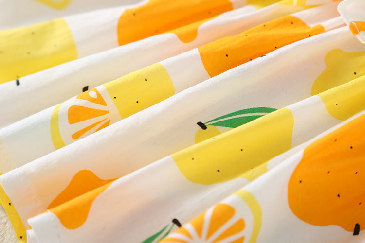Baby girl wearing a lemon fruit print sleeveless dress combo with short pants, showcasing vibrant colors and a playful design.