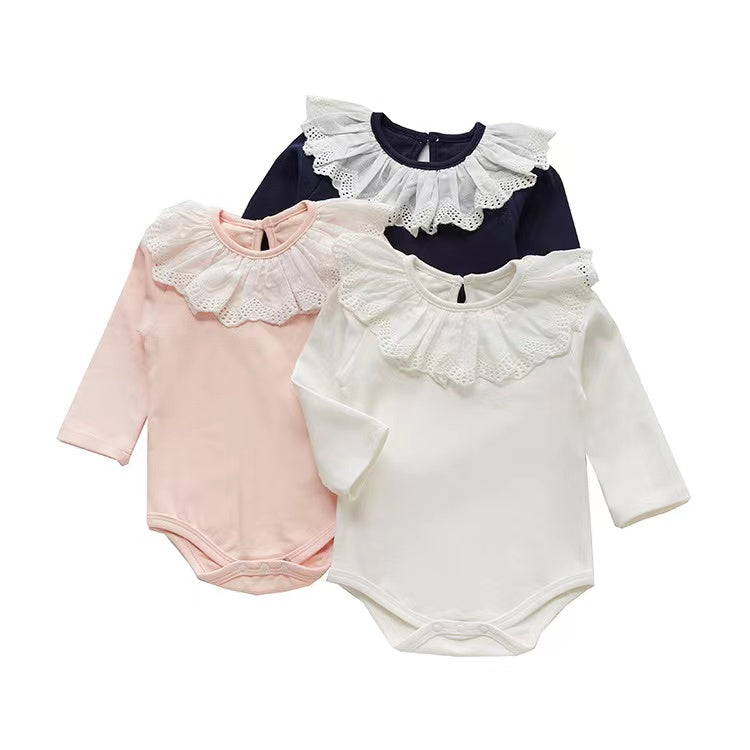 Adorable baby girl wearing a mesh ruffle neck long sleeved onesie in solid color, showcasing comfort and style.