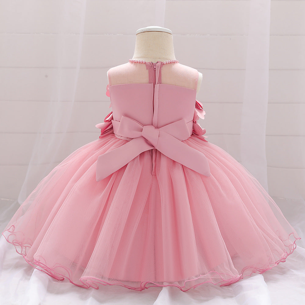 Baby girl wearing a petal patched design sleeveless full moon christening mesh dress in a beautiful floral pattern.